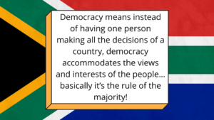 Text block with South African flag background, text describing what democracy is.